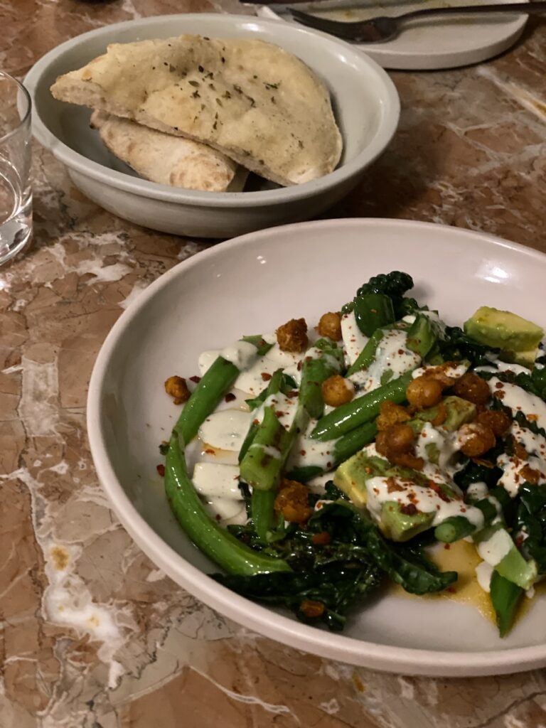 A plate of greens and fresh bread at Chez Nina