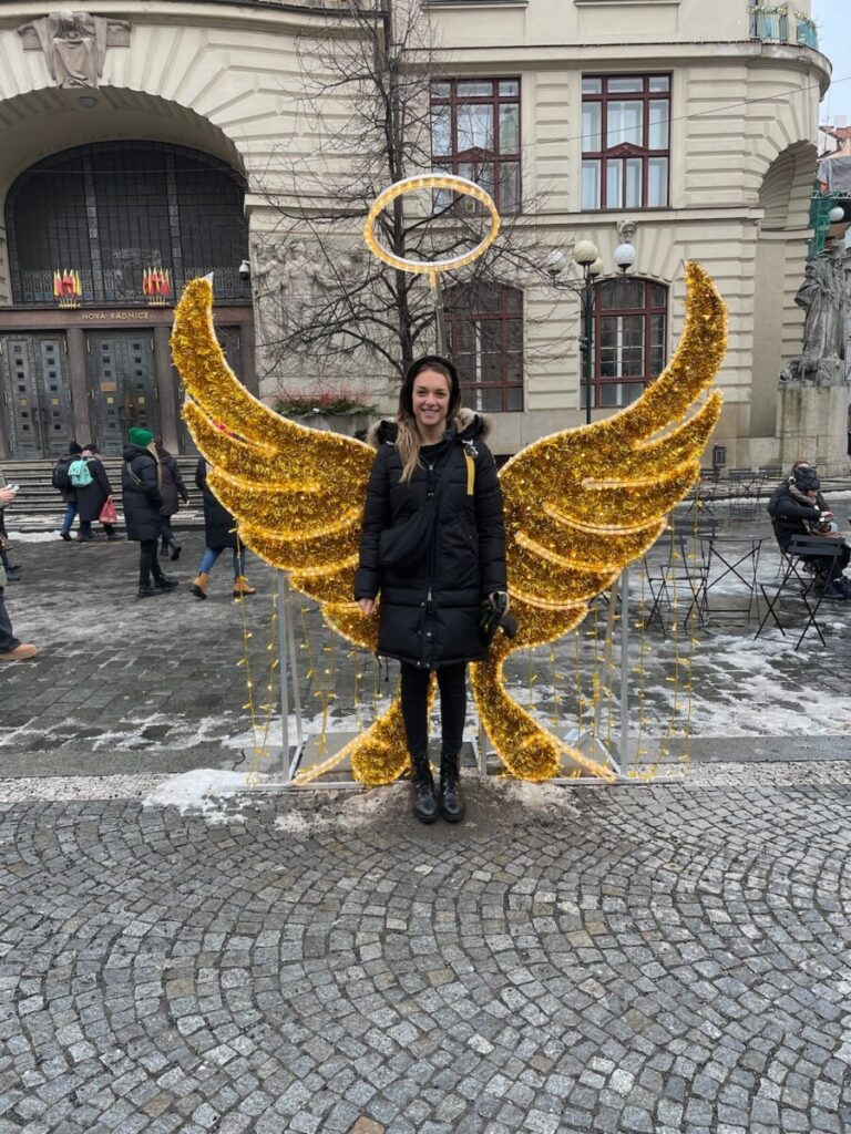 Me standing in Angel wings in Prague