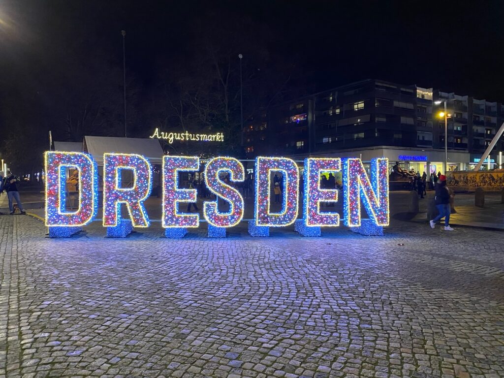 DRESDEN sign lit up at night at the Augustusmarkt, Dresden