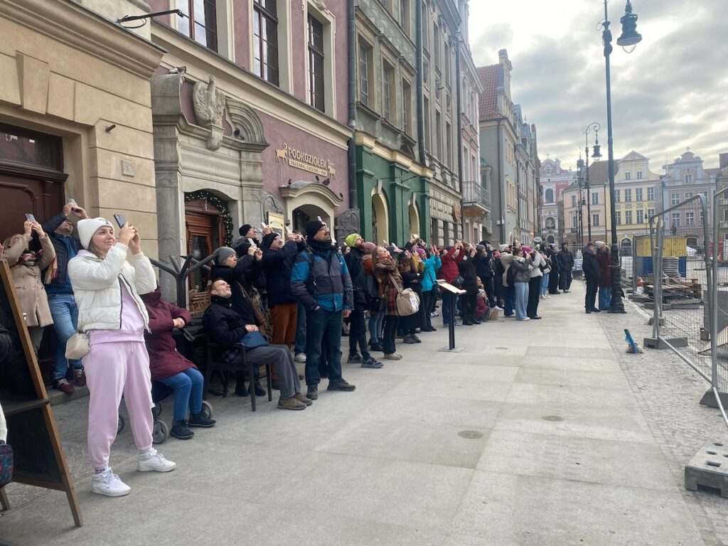 Poznan old town square people watching the billy goats